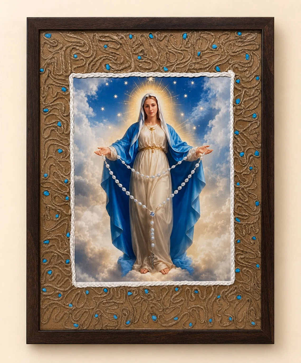 Framed image of Mother Mary with outstretched arms and a white rosary, surrounded by a textured gold-toned border with turquoise-coloured accents.